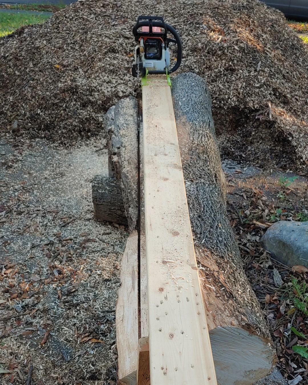 Jig attached to odd shaped log almost through first cut